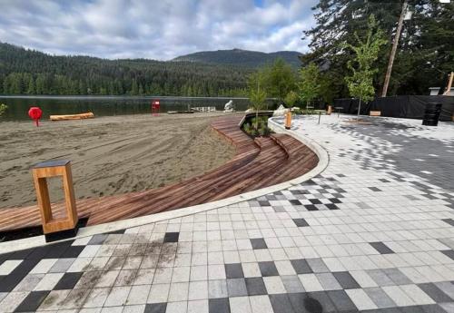a rendering of a beach with a bench and water at The Owls Nest at Westwood Lake in Nanaimo