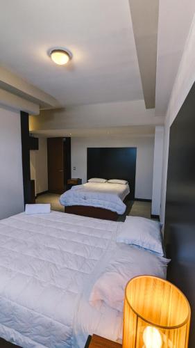 Katil atau katil-katil dalam bilik di Casa Buena Hotel