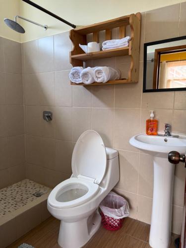 a bathroom with a toilet and a sink at Villas JABEL TINAMIT in Panajachel