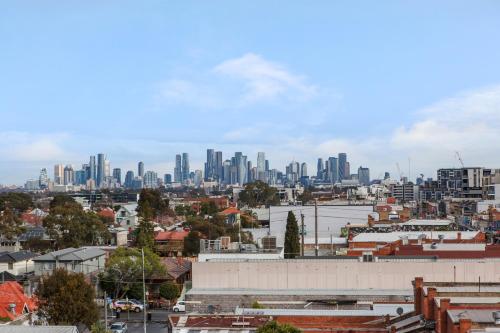 a cityscape of a city with tall buildings at Artel Apartments Brunswick in Melbourne