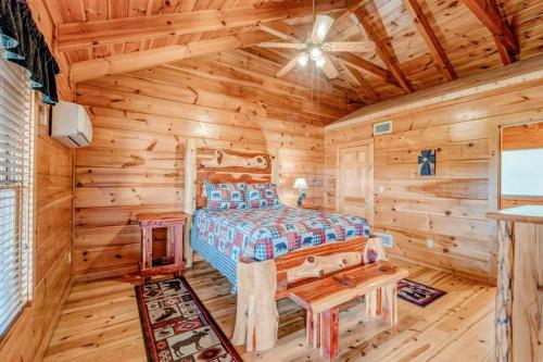 a bedroom with a bed in a log cabin at Natures Hideaway in Sevierville