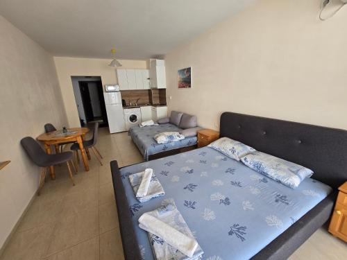 a living room with a bed and a couch at Студиa Блу минута от плажа in Pomorie