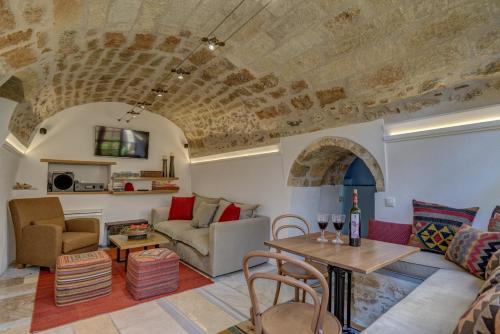 a living room with a couch and a table at Malvasia Traditional Hotel in Monemvasia