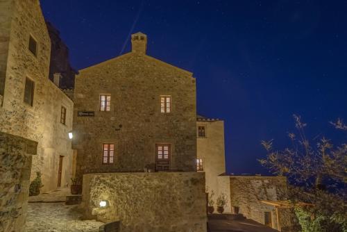 an old stone building at night at Malvasia Traditional Hotel in Monemvasia
