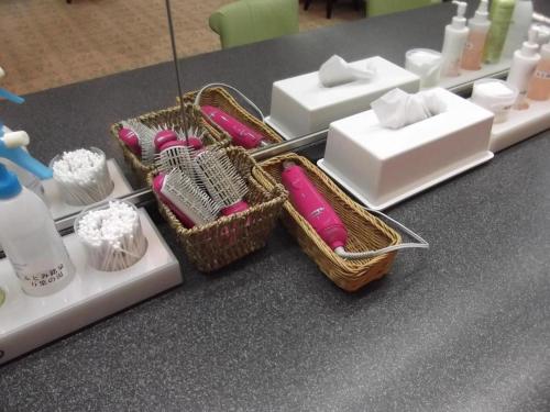 a table topped with white and pink soap and containers at Hokkaido Futomi Meisen Manyo no Yu in Sapporo
