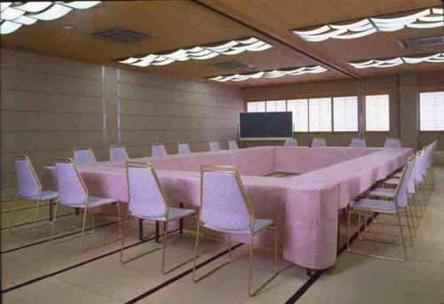 a large pink table and chairs in a room at Futami Onsen Hotel Seikai in Ise
