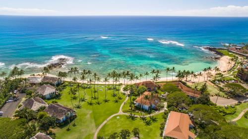 an aerial view of the beach and the ocean at Castle Kiahuna Plantation & Beach Bungalows in Koloa