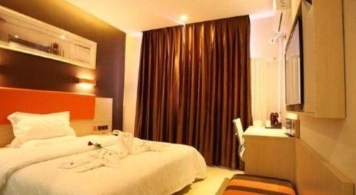 a hotel room with a bed and a window at 7 Days Premium Beijing Dabaotai Metro Station Luhua Road in Beijing