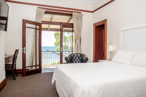 a bedroom with a bed and a view of the ocean at Streaky Bay Hotel Motel in Streaky Bay