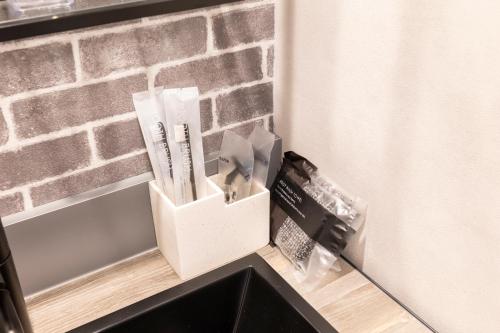 a corner of a kitchen with a brick wall at ALPHA BASE TakamatsuNishi in Takamatsu