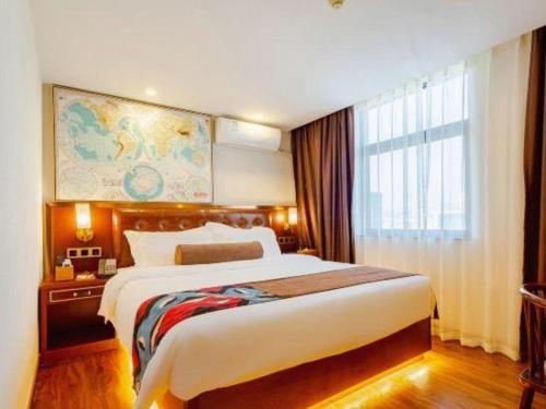 a hotel room with a large bed and a window at James Joyce Coffetel Guilin Railway Station Xiangbi Mountain Liangjiang Sihu Wharf in Guilin