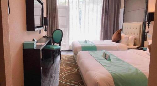 a hotel room with two beds and a television at Xana Hotelle Xi'an Zhonglou, Huimin Street Metro Station in Xi'an