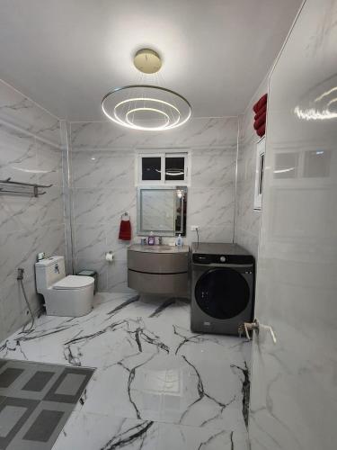 a marble bathroom with a sink and a toilet at Stargazers Luxury Condo Complex apartments in Ocoy