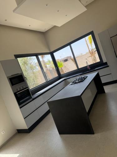 a room with a table and some windows at La Villa K Marrakech jacuzzi chauffé in Marrakech