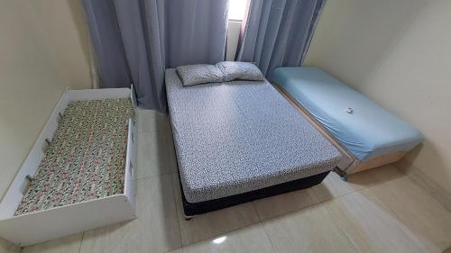 two beds in a room with a window at Bela casa nova na Chapada dos Guimarães in Chapada dos Guimarães