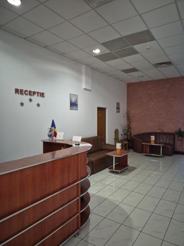 a waiting room with couches and tables in a lobby at Pensiunea MERCUR in Cluj-Napoca
