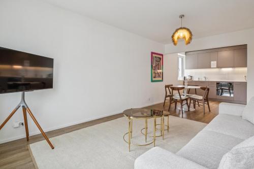a living room with a couch and a table at UP&GREAT Apartments - Chic Urban Homes in Zürich