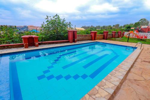 a large swimming pool with blue water at Myla homes in Kiambu