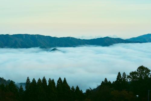 a sea of clouds in the mountains with trees at LUONTE 霧の高原 Glamping in Dōnaru