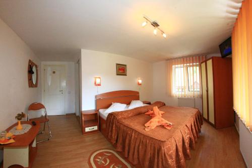 a bedroom with a bed with an orange animal on it at Vila Doina Branului in Bran