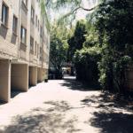 an empty street in front of a building at H & D Apartments in Melbourne