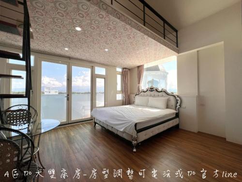 a bedroom with a bed and a large window at 夢幻城堡民宿 in Wujie