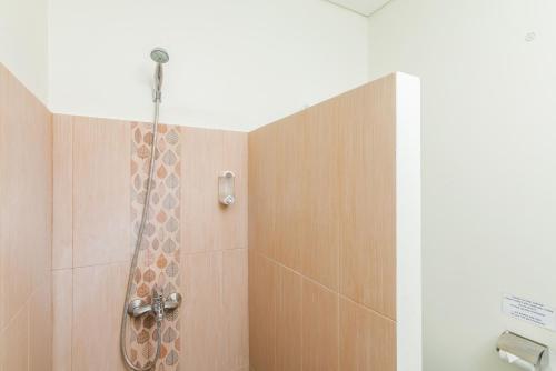 a bathroom with a shower with a shower head at Mi Casa Residence in Seminyak