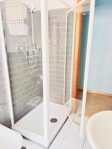 a shower with a glass door in a bathroom at Le antiche mura in Civitavecchia