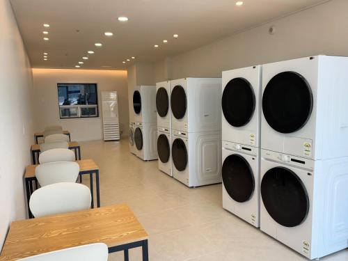 a row of washers and dryers in a laundry room at Geoje Ocean Hotel in Geoje 