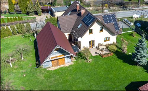 an aerial view of a house with solar panels on it at Dom pod górką in Bystrzyca Kłodzka