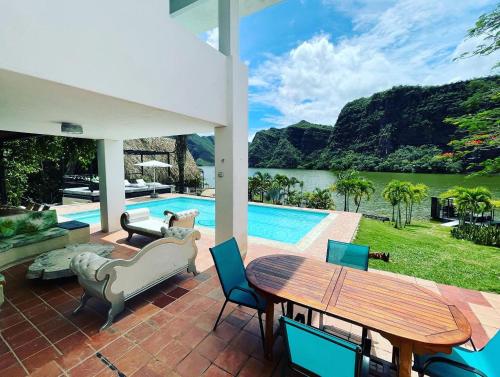 a patio with a table and chairs and a pool at Mansion del Lago - Hotel Prado in Prado
