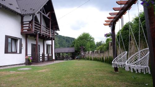 a group of chairs in a yard next to a building at Olko House in Yaremche