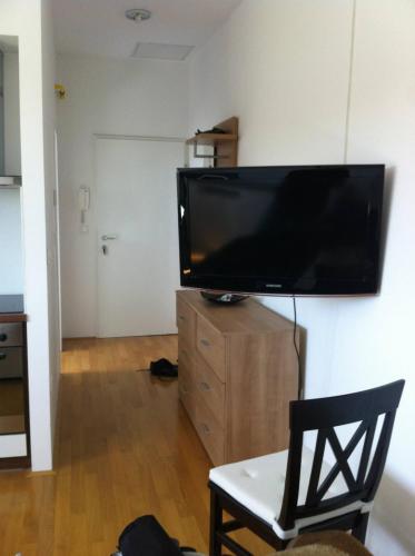 a living room with a large flat screen tv on a wall at Andro studio apartment in Ljubljana