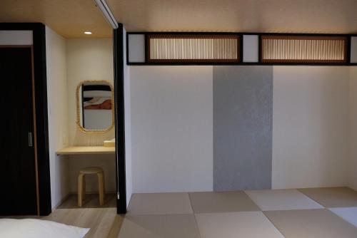 a bedroom with a bunk bed and a mirror at Jasmin錦町5-6 高松駅近 2階層 テラス付き in Takamatsu
