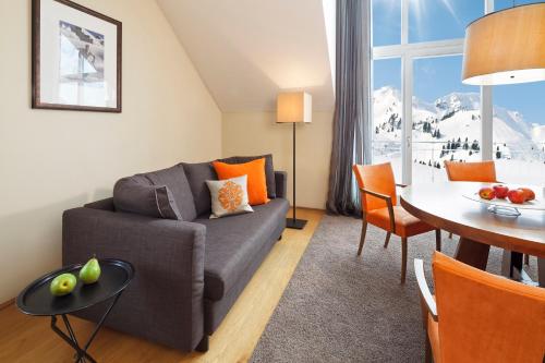 a living room with a couch and a table at Apparthotel Sonne in Obertauern