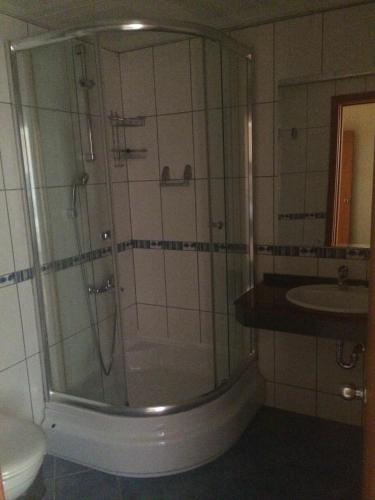 a bathroom with a shower and a toilet and a sink at Villa Beldeniz in Oludeniz