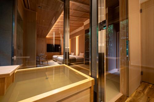 a room with a bathtub in the middle of a room at プライベートリゾート仙居 in Hakone