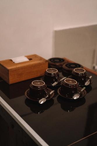 a stove top with four pots and spoons on it at Clamonic Villa Ubud - Monthly Rental Available in Sukawati