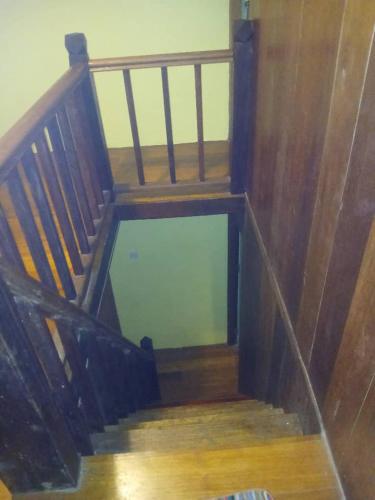 a wooden stairway with a wooden railing at Hotel Lang Hoose in George Town