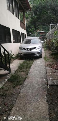 a silver car parked in front of a house at Kraken Haus Reef & Reel Lodge in Drake