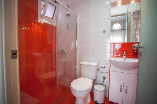 a bathroom with a toilet and a sink and a shower at Paraskevi's Luxury Studios in Parga