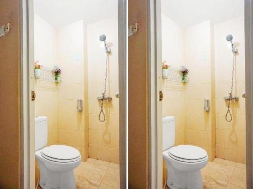 a bathroom with two toilets in a room at Capital O 91651 Independent99 Near Kalibata city square in Jakarta