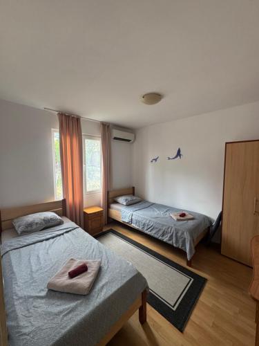 a bedroom with two beds and a window at Cozy House with Free parking in Varna City