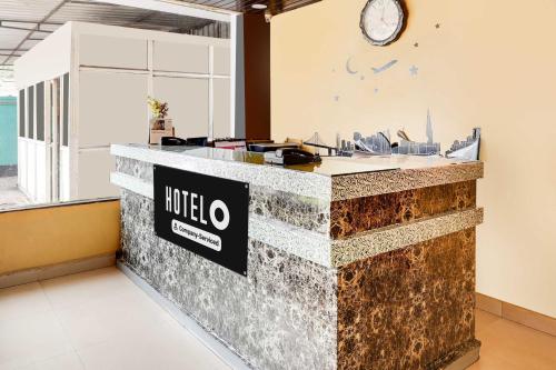 a lobby with a counter with a hotel sign on it at Hotel O Visakhapatnam Railway Station in Visakhapatnam