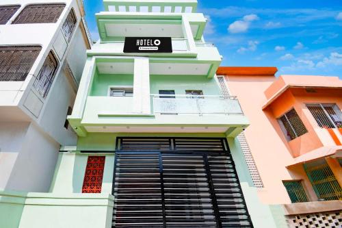 a building with a sign on the side of it at Hotel O VIP Road Near Golden Beach in Puri