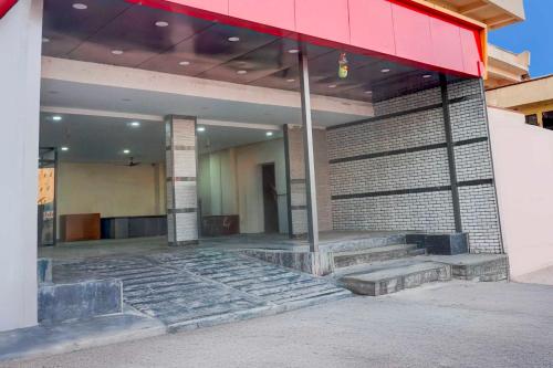 a building with steps in front of a building at Hotel O Talwade in Pune