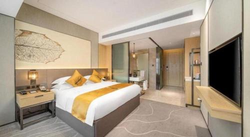 Ένα ή περισσότερα κρεβάτια σε δωμάτιο στο ZHONG DING HOTEL