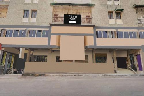 a building with a sign on the side of it at Hotel O Maninagar East in Ahmedabad