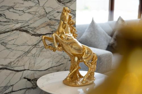 a gold statue of a dog on a table at Al Shatti Villas in Salalah