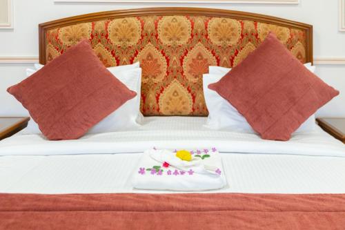 a tray with flowers on it sitting on a bed at Al Shatti Villas in Salalah